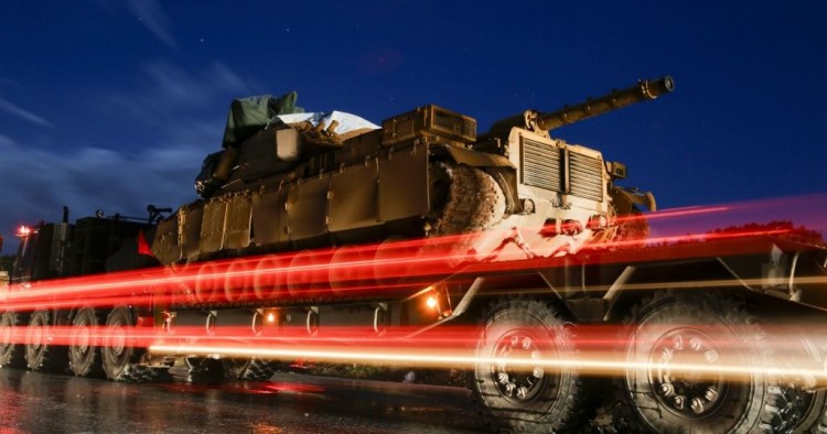  A Turkish military convoy of tanks and armoured vehicles passes through the city of Idlib, in northwestern Syria, near the Syria-Turkey border, late on February 7, 2020.