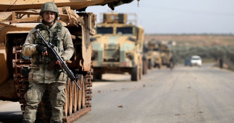 A Turkish soldier stands in front of a military vehicles convoy east of Idlib city in northwestern Syria on February 20, 2020 amid ongoing regime offensive on the last major rebel bastion in the country's northwest. 