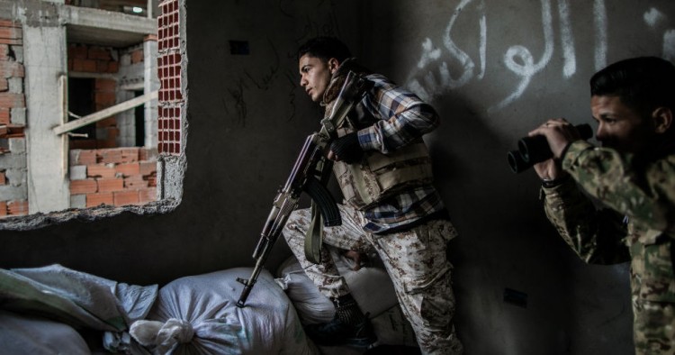  Fighters of the UN-backed Government of National Accord take cover during clashes with Libyan National Army forces at Al-Nahr frontline in Tripoli, Libya, on March 8, 2020. 