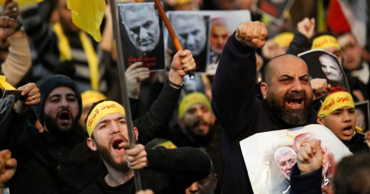 Supporters shout slogans during a rally for Qassem Soleimani in southern suburbs of Beirut, Lebanon, on Jan. 5, 2020. Hezbollah leader Sayyed Hassan Nasrallah urged on Sunday its fighters to attack U.S. soldiers in the region in retaliation for the assassination of Iranian top commander Qassem Soleimani by the United States. (Photo by Bilal Jawich/Xinhua via Getty) (Xinhua/ via Getty Images)