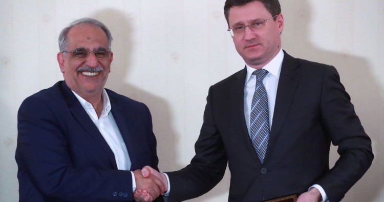 Iran's Minister of Economic Affairs and Finance, Masoud Karbasian (L) and Russias Energy Minister Alexander Novak shake hands at a signing ceremony following a meeting of the Russian-Iranian intergovernmental commission for trade and economic cooperation at Moscow's President Hotel