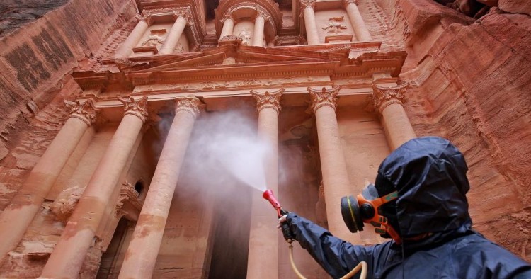 A labourer sprays disinfectant in Jordan's archaeological city of Petra south of the capital Amman on March 17, 2020, to prevent the spread of COVID-19. 