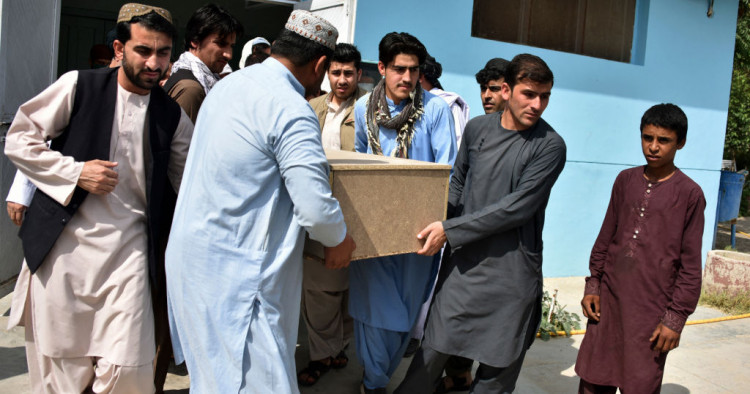 Relatives carry a coffin with the body of television journalist Nemat Rawan after he was shot dead by gunmen, in Kandahar Provicne on May 6, 2021.