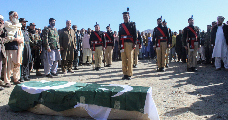 Security officials and relatives attend a funeral ceremony of a slain policeman, who was killed in an attack claimed by the Tehreek-e-Taliban Pakistan (TTP), in the border town of Chaman on January 28, 2022. (Photo by Abdul BASIT / AFP) (Photo by ABDUL BASIT/AFP via Getty Images)