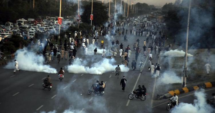 Pakistani security forces respond to protesters with tear gas as thousands of supporters of Pakistan's former Prime Minister Imran Khan took to the streets to protest against his disqualification by the election authority in Islamabad, Pakistan on October 21, 2022.