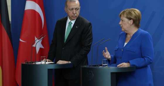 Recep Tayyip Erdogan and Angela Merkel at podium 