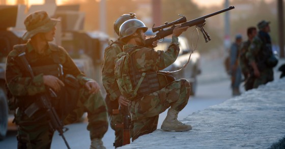 An Afghan soldier aims his gun as he guards the area surrounding the Intercontinental hotel during a military operation against Taliban militants that stormed the hotel in Kabul on June 29, 2011.