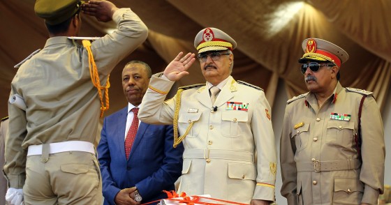 Libyan Strongman Khalifa Haftar salutes next to Libyan National Army's Chief Of Staff Abdelrazak al-Nadhuri and Libyan former prime minister Abdullah al-Thani.