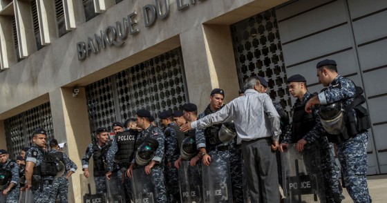 A demonstrator argues with riot police guarding the entrance of the Lebanese Central Bank during a protest by retired Lebanese army and security personnel as part of a preemptive strike against austerity measures in the 2019 draft state budget that might affect their retirement wages.