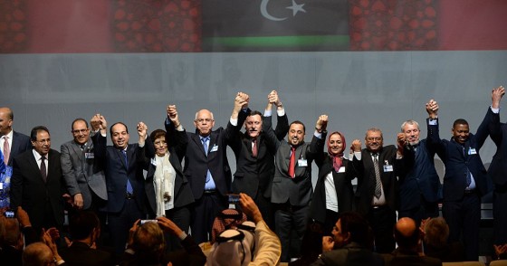 Libya's General National Congress (GNC) deputy president Saleh al-Makhzoum (C-R), the new national government head, Prime Minister, Fayez al-Sarraj (C) and the head of the Tobruk-based House of Representatives Mohammed Ali Shoeb (C-L) celebrate after signing a deal on a unity government on December 17, 2015, in the Moroccan city of Skhirat.