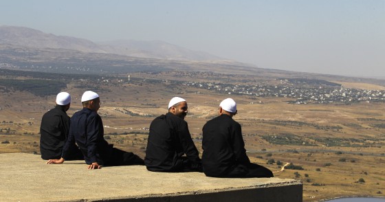 Cover photo: Druze men in the Israeli-annexed Golan Heights look out across the southwestern Syrian province of Quneitra, visible across the border on July 7, 2018. (Photo by JALAA MAREY/AFP/Getty Images)