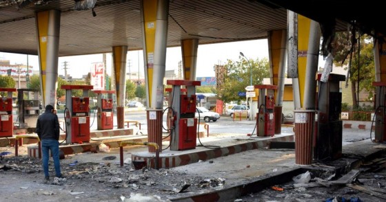 An Iranian man checks a scorched gas station that was set ablaze by protesters during a demonstration against a rise in gasoline prices in Eslamshahr, near the Iranian capital of Tehran, on November 17, 2019. 