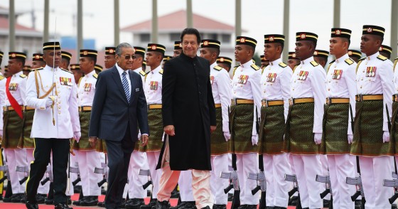Pakistan's Prime Minister Imran Khan (C) is accompanied by his Malaysian counterpart Mahathir Mohamad (L) as he reviews a guard of honour during a welcoming ceremony at the prime minister's office in Putrajaya on November 21, 2018. (Photo by Mohd RASFAN / AFP) (Photo credit should read MOHD RASFAN/AFP via Getty Images)