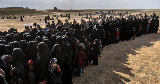 Civilians evacuated from the Islamic State (IS) group's embattled holdout of Baghouz wait for bread and water at a screening area held by the Kurdish-led Syrian Democratic Forces (SDF), in the eastern Syrian province of Deir Ezzor, on March 5, 2019. - More than 7,000 people, mostly women and children, have fled the shrinking pocket over the past two days, as US-backed forces press ahead with an offensive to crush holdout jihadists. (Photo by Bulent KILIC / AFP) (Photo credit should read BULENT KILIC/AFP via