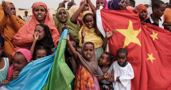 People hold Chinese and Djiboutian national flags as they wait for the arrival of Djibouti's President Ismail Omar Guellehas before the launching ceremony of new 1000-unit housing contruction project in Djibouti, on July 4, 2018. - The new 1000-unit construction project by the Ismail Omar Guelleh Foundation for Housing is financially supported by China Merchant, the operation parther of newly inaugurated Djibouti International Free Trade Zone (DITTZ) with Djibouti Ports and Free Zones Authority, to build ba