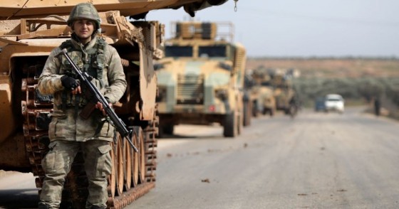 A Turkish soldier stands in front of a military vehicles convoy east of Idlib city in northwestern Syria on February 20, 2020 amid ongoing regime offensive on the last major rebel bastion in the country's northwest.