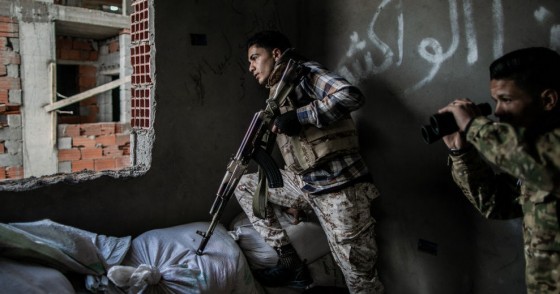 Fighters of the UN-backed Government of National Accord take cover during clashes with Libyan National Army forces at Al-Nahr frontline in Tripoli, Libya, on March 8, 2020.