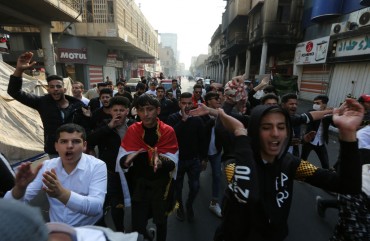 Iraqi protesters chant slogans during a demonstration in Baghdad's al-Rasheed street near al-Ahrar bridge on November 24, 2019.