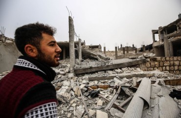 A man is seen around debris of buildings after warplanes belonging to Assad Regime hit Ma'ar Shoreen village, in Ma'arat al-Nu'man district of of Idlib, de-escalation zone, Syria on December 15, 2019.