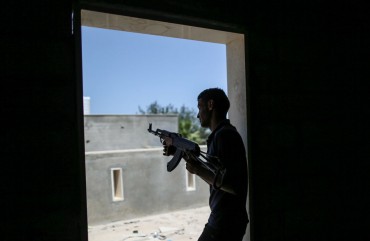 A fighter of Libya's UN-backed Government of National Accord (GNA) of Fayez Serraj, fires his rifle during clashes with forces of the self-styled Libyan National Army (LNA) led by Libyan strongman Khalifa Haftar, at Al-Khalla frontline.