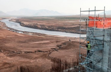 A worker goes down a construction ladder at the Grand Ethiopian Renaissance Dam (GERD), near Guba in Ethiopia, on December 26, 2019.