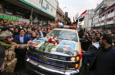 Mourners surround a car carrying the coffins of Iranian military commander Qasem Soleimani and Iraqi paramilitary chief Abu Mahdi al-Muhandis, killed in a US air strike, during their funeral procession in Kadhimiya, a Shiite pilgrimage district of Baghdad, on January 4, 2020.