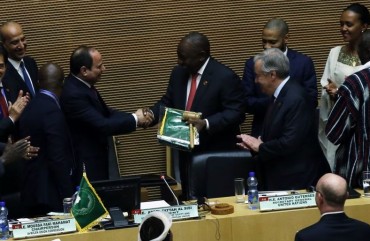 South African President Cyril Ramaphosa (5th R) assumes gavel for a year-long African Union (AU) presidency from the outgoing Abdel-Fattah El-Sisi (5th L), the Egyptian president, during the 33rd African Union Heads of State Summit in Addis Ababa, Ethiopia on February 09, 2020.