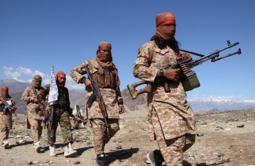 Afghan Taliban fighters and villagers attend a gathering as they celebrate the peace deal signed between US and Taliban in Laghman Province, Alingar district on March 2, 2020. 