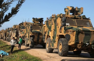 A Turkish military convoy is seen parked near the town of Batabu on the highway linking Idlib to the Syrian Bab al-Hawa border crossing with Turkey, on March 2, 2020. 