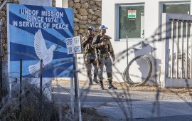 UNDOF forces stand guard at the entrance to the UN headquarters, in the demilitarized zone, near the Quneitra border crossing in the Israeli annexed Golan Heights on September 5, 2014
