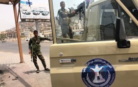 A fighter of the UAE-trained Security Belt Force, dominated by backers of the the Southern Transitional Council (STC) which seeks independence for south Yemen, mans the turret of a technical (pickup truck mounted with an anti-aircraft gun) displaying portraits of separatist leader Aidarus al-Zubaidi and showing the logo of the STC, in the Crater district in the centre of Yemen's second city of Aden on August 12, 2019.