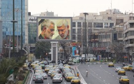 A billboard bearing a portrait with the black mourning ribbon of slain Iranian military commander Qasem Soleimani (L) and Iraqi paramilitary chief Abu Mahdi al-Muhandis hangs on a main road in the Iranian capital Tehran on January 4, 2020, one day after Soleimani and other members of the pro-Iranian Iraqi paramilitary group Al-Hashed Al-Shaabi were killed in a US air strike near Baghdad international airport. 
